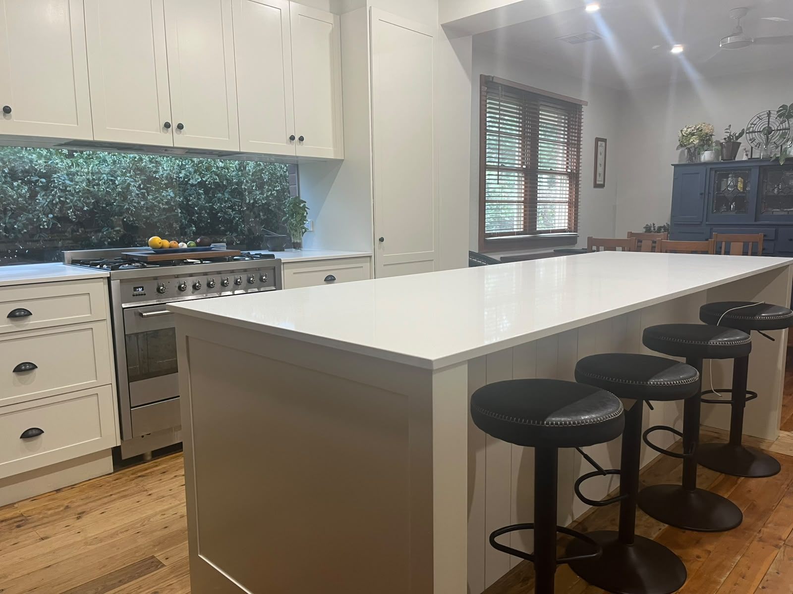 Shaker kitchen with large stone-topped island and VJ panelling